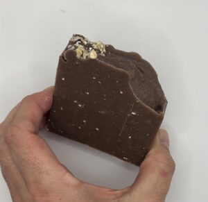 Image of a brown soap with flecks of oatmeal
